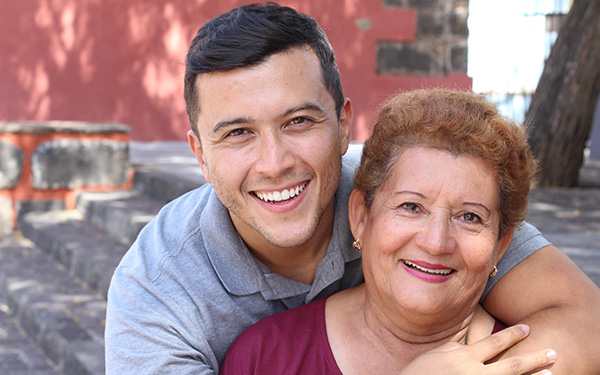 Carlos and his mother smiling